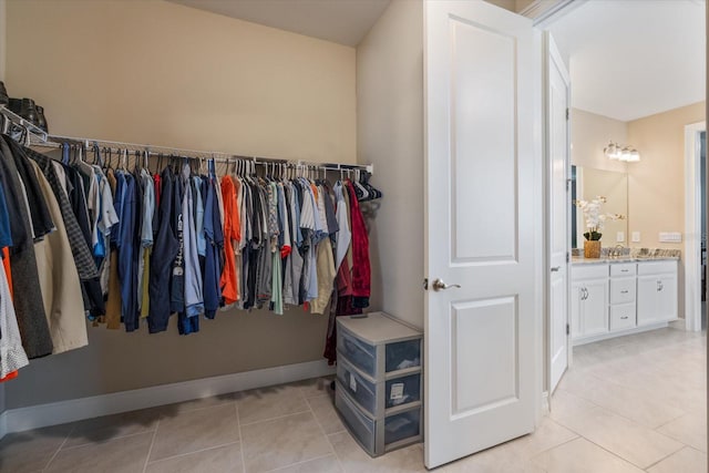 walk in closet with light tile patterned floors