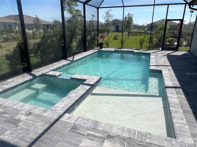 view of pool with a patio, a lanai, and a pool with connected hot tub