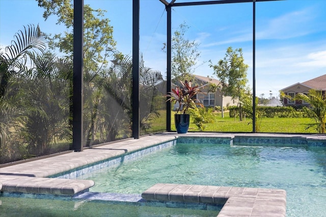 view of swimming pool with a yard, a lanai, and a pool with connected hot tub