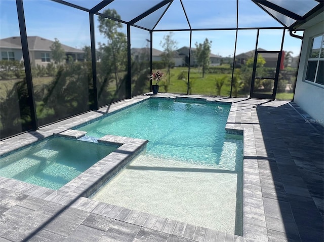 view of pool featuring a patio area, a lanai, and a pool with connected hot tub