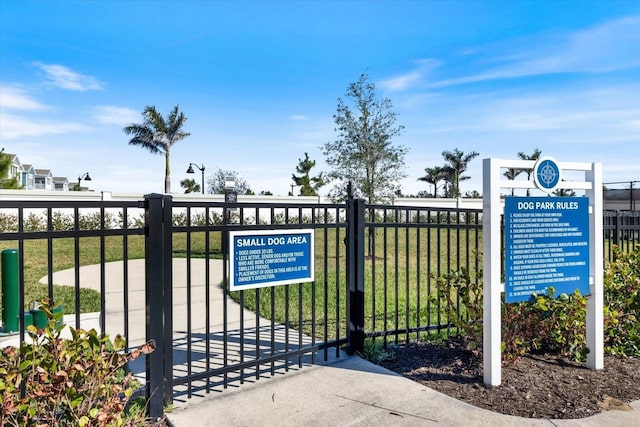 view of gate featuring a yard and fence