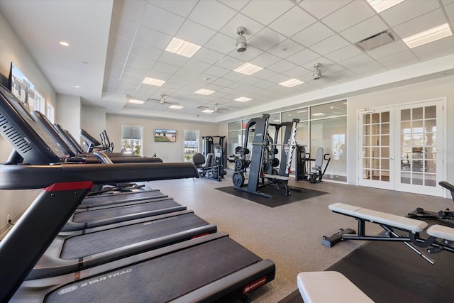 workout area with french doors, a paneled ceiling, and visible vents