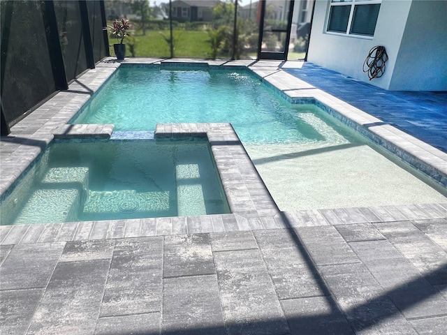 view of pool with glass enclosure, a patio, and a pool with connected hot tub