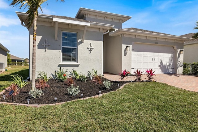 view of front of home featuring stucco siding, central air condition unit, a front lawn, decorative driveway, and an attached garage