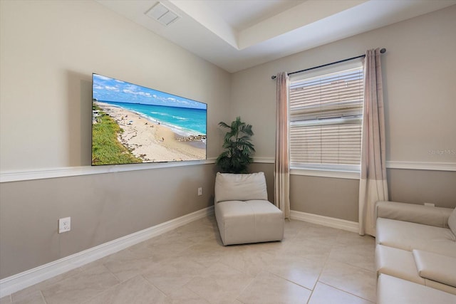 sitting room with tile patterned floors, visible vents, and baseboards