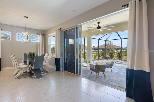 dining area with light tile patterned floors, plenty of natural light, baseboards, and a sunroom