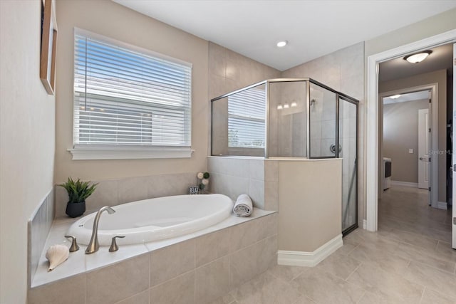 full bath featuring tile patterned floors, a shower stall, and a garden tub