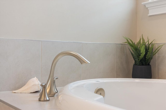 details with a jetted tub and a sink