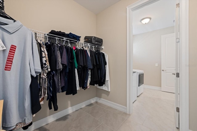 spacious closet with tile patterned floors and washing machine and dryer