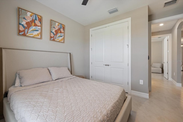 bedroom featuring baseboards, visible vents, a closet, and ceiling fan