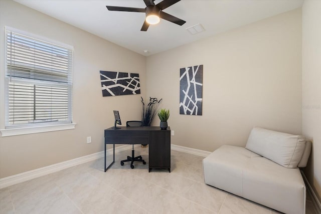 office area featuring light tile patterned flooring, visible vents, a ceiling fan, and baseboards