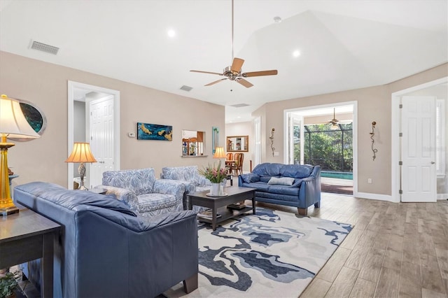 living room featuring baseboards, wood finished floors, visible vents, and ceiling fan