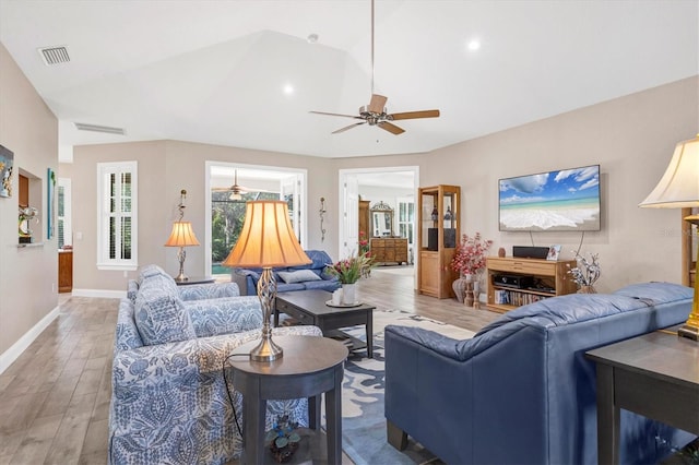 living area featuring baseboards, light wood-style floors, visible vents, and ceiling fan