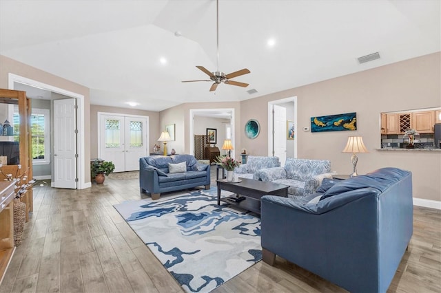 living room featuring visible vents, light wood-style flooring, french doors, and ceiling fan