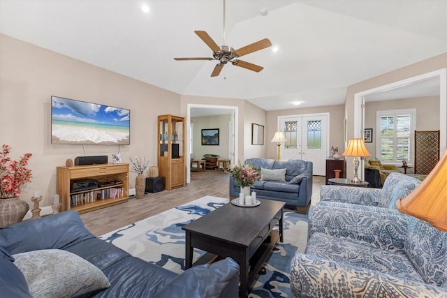 living room featuring lofted ceiling, wood finished floors, and a ceiling fan