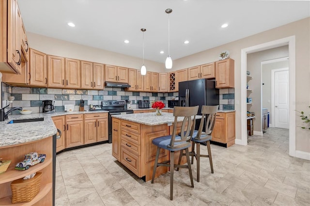 kitchen featuring light stone countertops, under cabinet range hood, electric range oven, black fridge with ice dispenser, and a sink