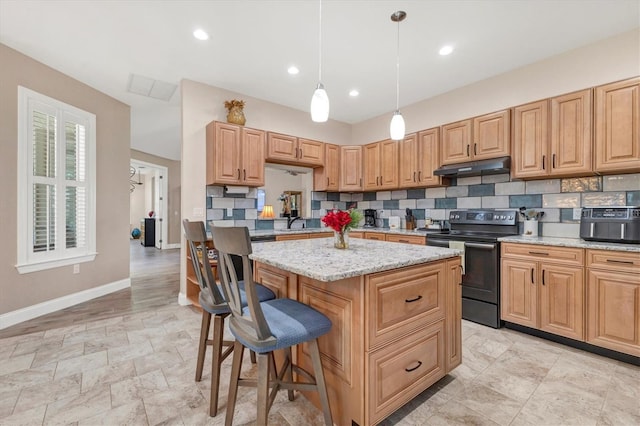 kitchen featuring tasteful backsplash, a kitchen island, under cabinet range hood, a kitchen bar, and electric range