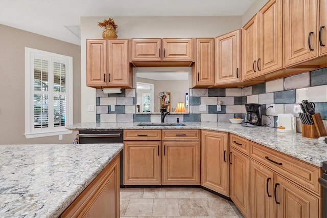 kitchen featuring light stone countertops, tasteful backsplash, and dishwasher