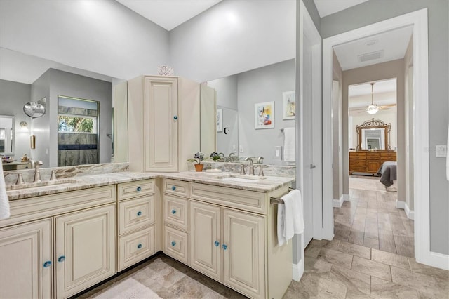 bathroom with double vanity, visible vents, ceiling fan, and a sink