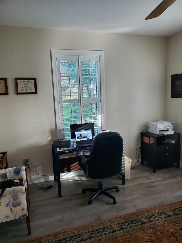 office space featuring light wood-type flooring and a ceiling fan