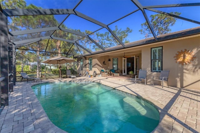 pool with glass enclosure and a patio