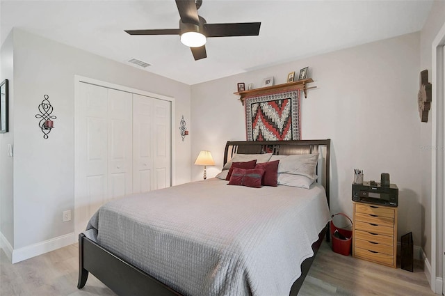 bedroom featuring a closet, baseboards, and wood finished floors