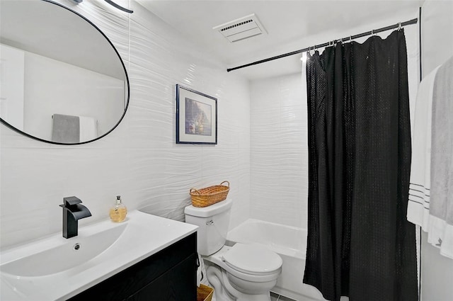 bathroom with visible vents, toilet, shower / bathtub combination with curtain, vanity, and tile walls