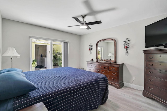 bedroom featuring light wood-type flooring, access to exterior, multiple windows, and baseboards