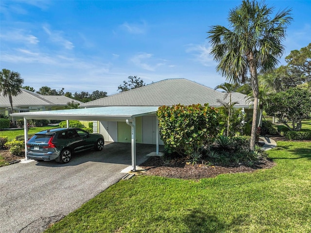 view of home's exterior with driveway, an attached carport, and a lawn