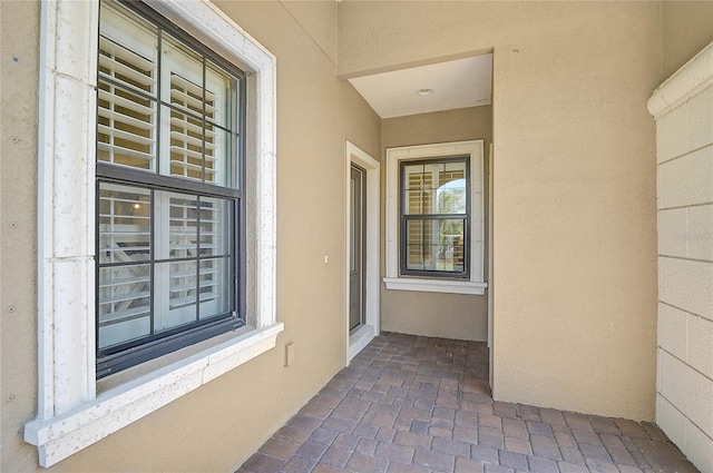 doorway to property featuring stucco siding