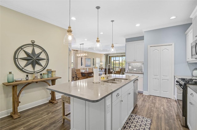 kitchen featuring stainless steel appliances, white cabinetry, a sink, and dark wood-style floors