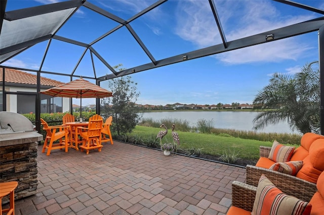 view of patio with a water view and glass enclosure