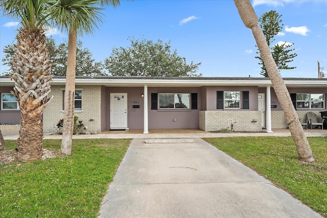 single story home with a front lawn and brick siding