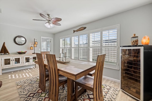 929 The Rialto, Venice, FL 34285 - dining space with light wood-style floors, beverage cooler, visible vents, and a ceiling fan
