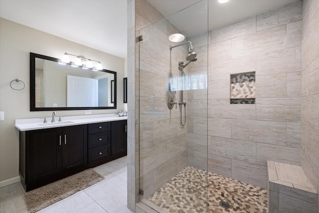 929 The Rialto, Venice, FL 34285 - bathroom featuring a tile shower, double vanity, a sink, and tile patterned floors