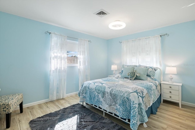 929 The Rialto, Venice, FL 34285 - bedroom featuring baseboards, visible vents, and wood finished floors