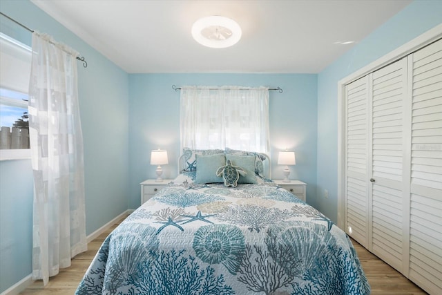 929 The Rialto, Venice, FL 34285 - bedroom featuring a closet, light wood-type flooring, and baseboards