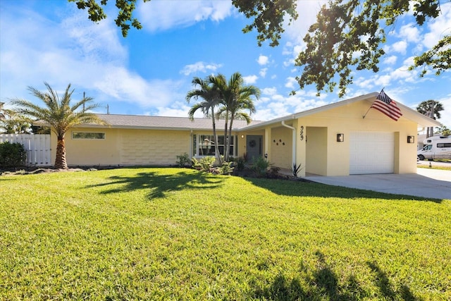 ranch-style house with an attached garage, fence, driveway, stucco siding, and a front yard