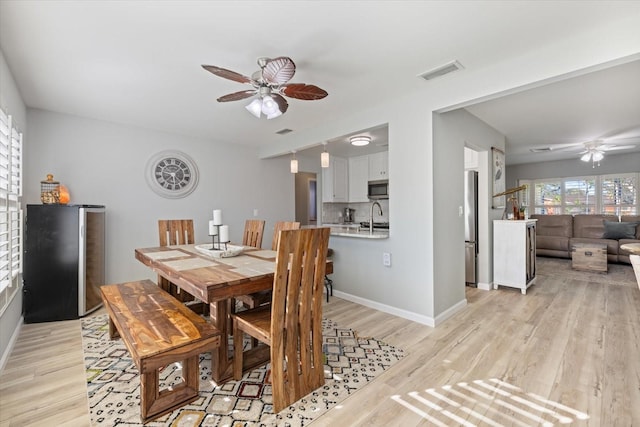 929 The Rialto, Venice, FL 34285 - dining area with light wood-style floors, visible vents, ceiling fan, and baseboards