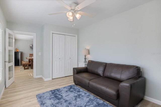 929 The Rialto, Venice, FL 34285 - living area with light wood-type flooring, baseboards, a ceiling fan, and french doors