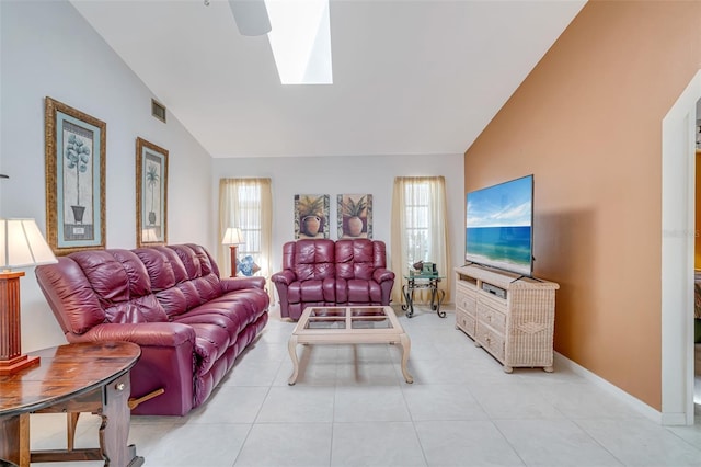 5875 Jackson, Venice, FL 34293 - living room featuring light tile patterned floors, high vaulted ceiling, a skylight, visible vents, and baseboards