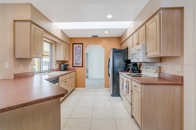 5875 Jackson, Venice, FL 34293 - kitchen featuring arched walkways, white appliances, light brown cabinets, and a sink