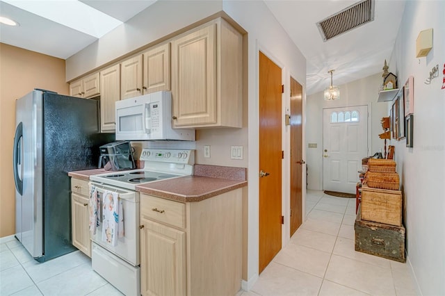5875 Jackson, Venice, FL 34293 - kitchen featuring light tile patterned floors, white appliances, visible vents, hanging light fixtures, and light brown cabinetry