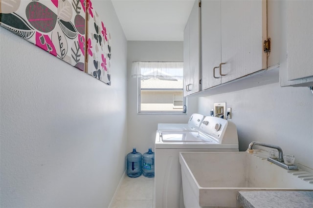 5875 Jackson, Venice, FL 34293 - laundry area with light tile patterned floors, a sink, baseboards, cabinet space, and washer and clothes dryer