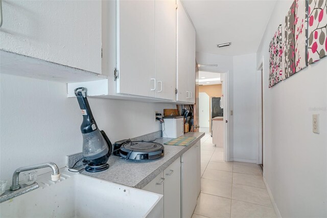 5875 Jackson, Venice, FL 34293 - kitchen featuring light tile patterned floors, a sink, visible vents, white cabinetry, and light countertops