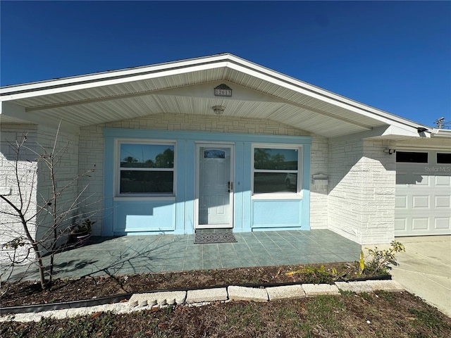 view of exterior entry featuring a garage