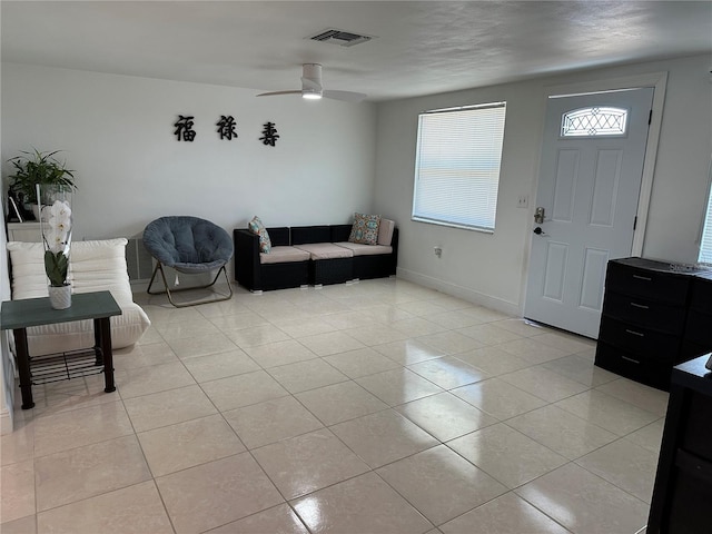 entryway featuring light tile patterned floors and ceiling fan