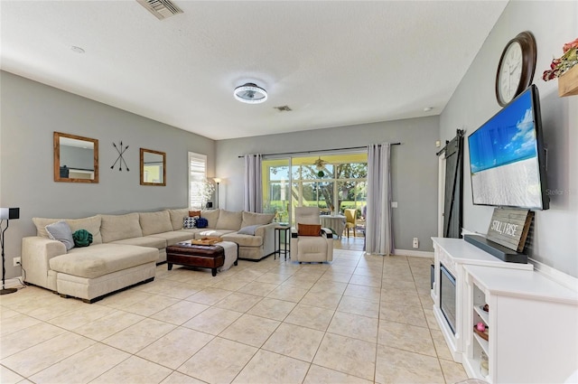 living room with light tile patterned floors and a textured ceiling