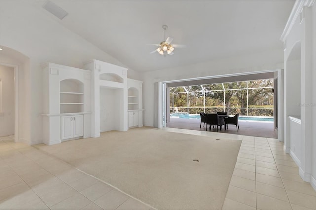 unfurnished living room with built in features, a sunroom, light carpet, and plenty of natural light