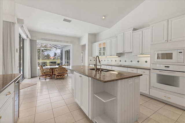 kitchen featuring white appliances, light tile patterned flooring, a sink, and visible vents